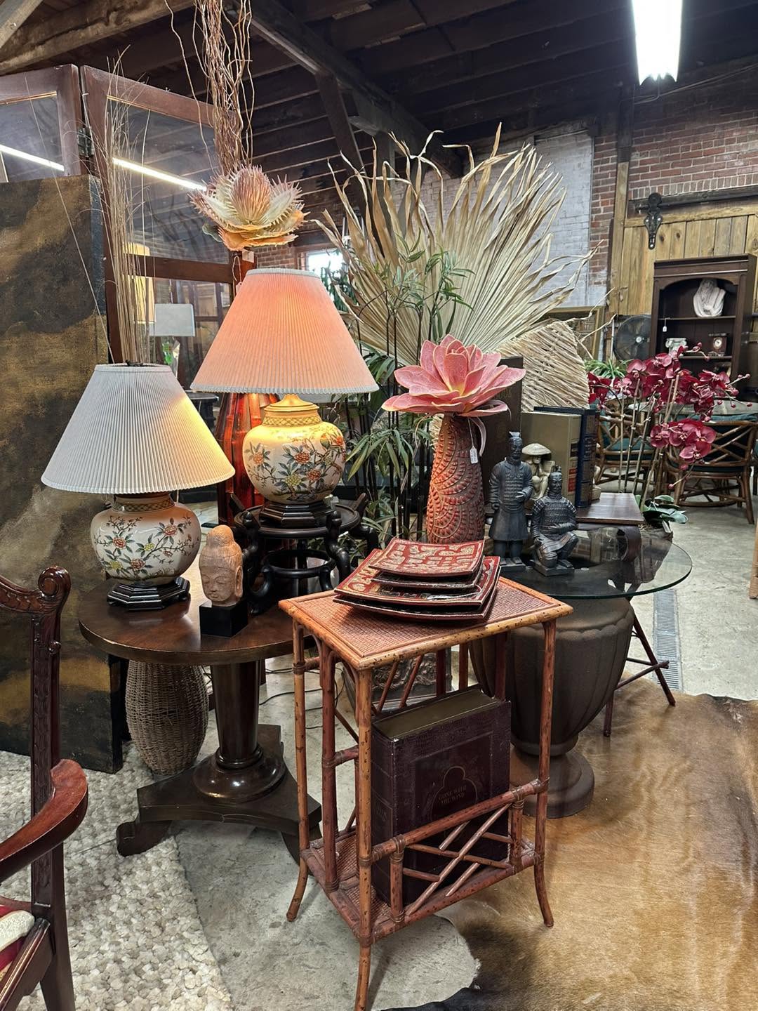 Lamps, florals, and bamboo accessories styled on a console